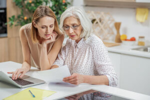 Family member reviewing documents to search for unclaimed money for a deceased relative